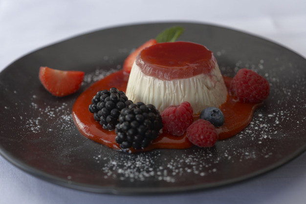 Panna cotta with jelly topping and berries